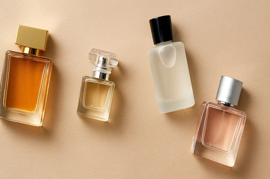 Four affordable perfume bottles arranged on a beige surface, showcasing budget-friendly fragrances for Singapore shoppers