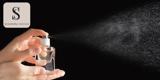 Hand spraying perfume from glass bottle into fine mist - Seraphine Scents