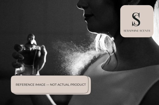 Woman spraying Jo Malone Yuja Cologne Perfume on shoulder showing fragrance mist in black and white