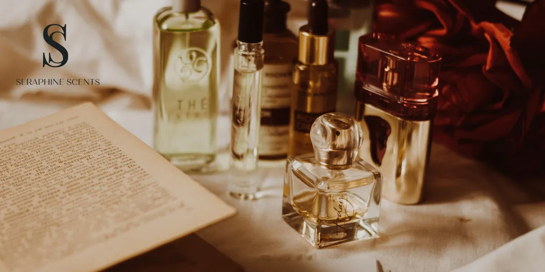 Collection of elegant luxury perfume bottles on a table with an open book and Seraphine Scents watermark
